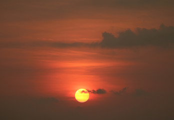 Tropical golden sunset on deep orange cloudy sky, seaside of Thailand 