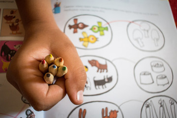 Coloring pages and crayons in hand