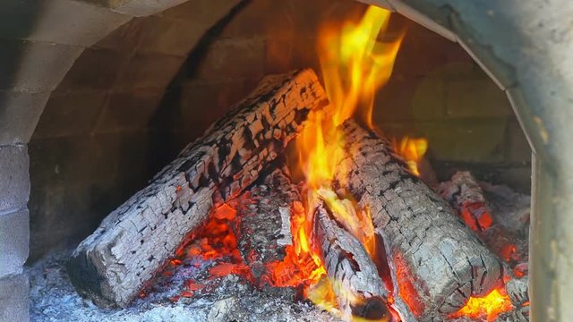 Glimpse into a wood fire oven before the pizza comes Slow motion