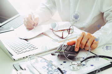 Healthcare costs and fees concept.Hand of smart doctor used a calculator for medical costs in...