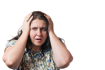 Unhappy brunette young woman holding hands on her head isolated on white background