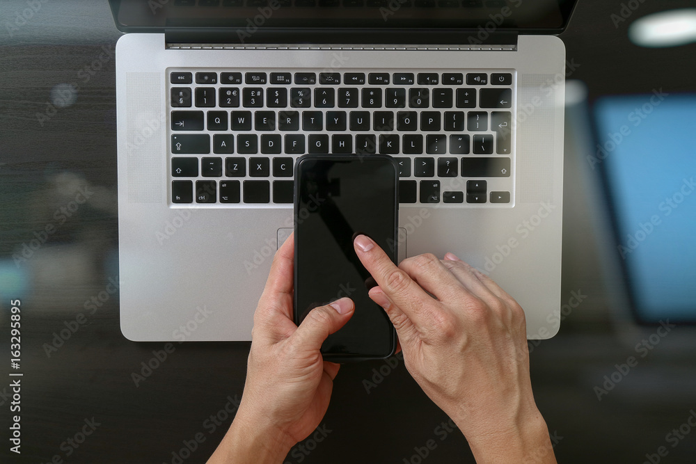 Poster cyber security internet and networking concept.businessman hand working mobile phone on laptop compu