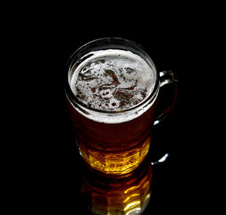 Vintage large glass of beer  on black background