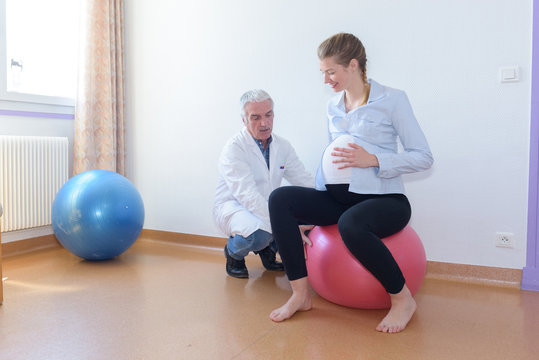 Pregnant lady sat on an aerobic ball