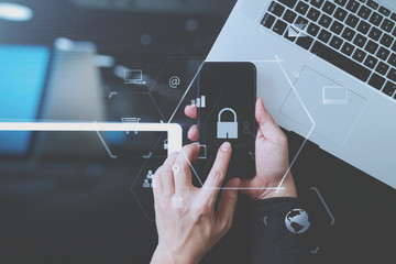cyber security internet and networking concept.Businessman hand working with VR screen padlock icon mobile phone on laptop computer and digital tablet - obrazy, fototapety, plakaty