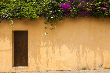 Window and wooden door in colonial house of La Antigua Guatemala, Central America.