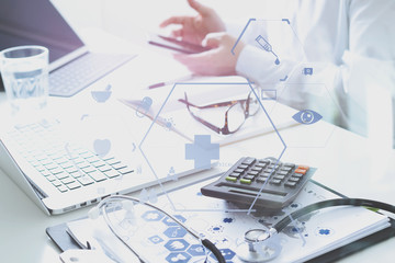 Healthcare costs and fees concept.Hand of smart doctor used a calculator for medical costs in modern hospital