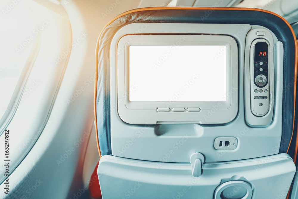 Wall mural empty white mock-up of aircraft multimedia screen with remote control, close-up view of blank placeh