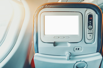Empty white mock-up of aircraft multimedia screen with remote control, close-up view of blank...