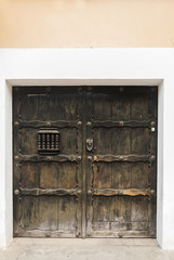 Window and wooden door in colonial house of La Antigua Guatemala, Central America.