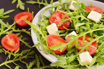 salad with tomatoes, fresh arugula and mozzarella