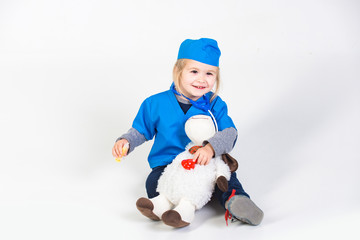vet kid in uniform playing doctor with toy animal