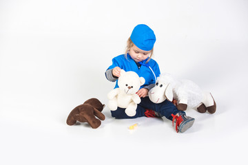 vet kid in uniform playing doctor with toy animal