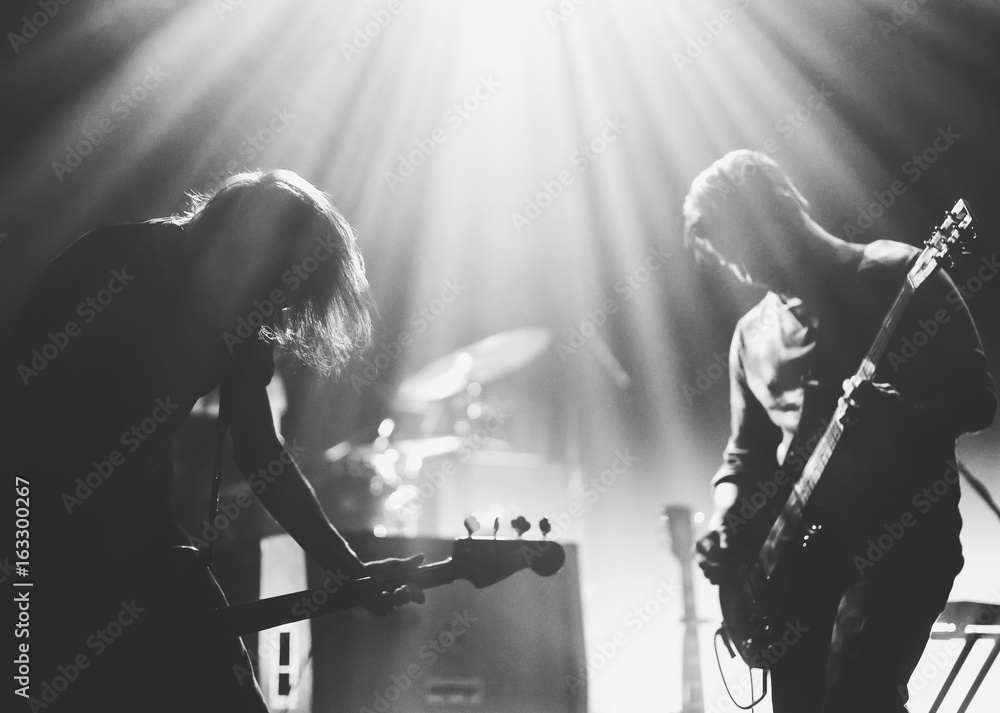 Wall mural Rock band on a stage in a backlights