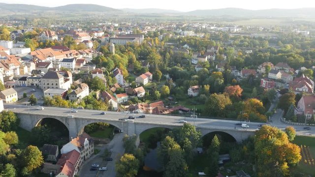 drone view over historical bridge, city traffic in green landscape, Bautzen, Germany 