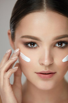 Beauty Cosmetics. Sexy Girl Face With Cosmetic Cream On Skin