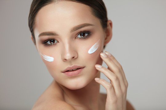 Woman Beauty Face Care. Portrait Of Female With Facial Cream