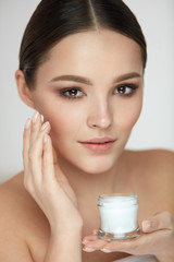 Face Skin Care. Beautiful Girl Putting Cream On Soft Smooth Skin