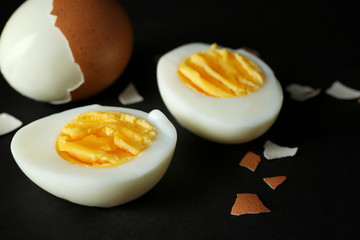 Hard boiled eggs on black background. Nutrition concept