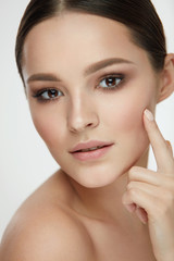 Obraz premium Beauty Skin Care. Sexy Female Touching Facial Skin With Finger