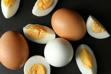 Hard boiled eggs on black background. Nutrition concept