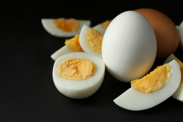 Hard boiled eggs on black background. Nutrition concept