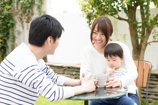 Young Asian Family Relaxing In Cafe