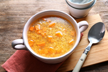 Composition with tasty lentil soup on wooden table, closeup