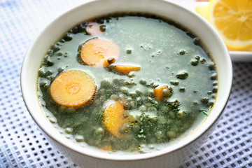 Bowl with tasty lentil dish on kitchen table, closeup