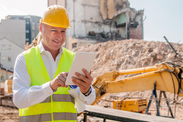 Builder worker activity with digital tablet on construction site