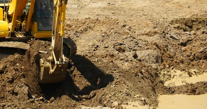 4k closeup excavator working & dumper truck on construction site,china.