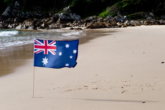Australian Flag waving in the wind on the beach