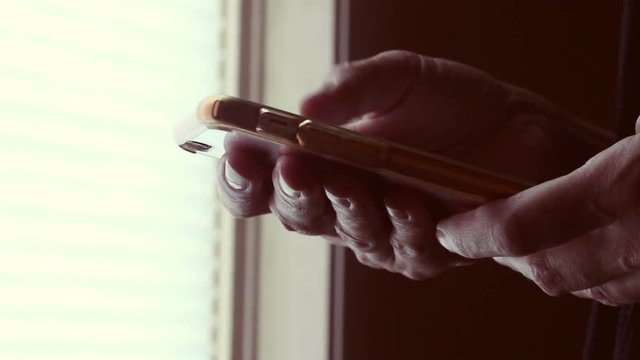 Ambient shot of smartphone used by female near home