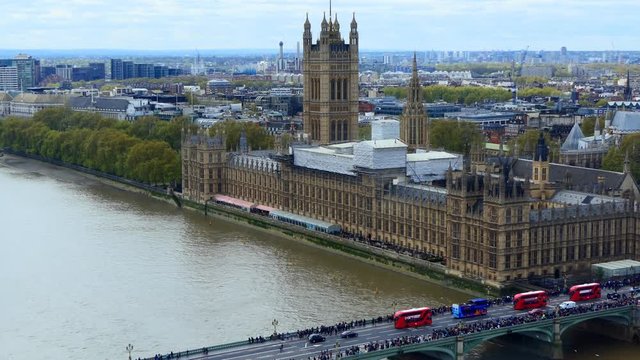 Aerial view of red buses on Westminster bridge, Houses of Parliament and panorama of London, the United Kingdom capital city