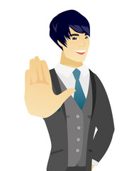 Young asian groom showing palm hand.