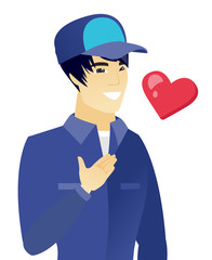 Young asian mechanic holding hand on his chest.