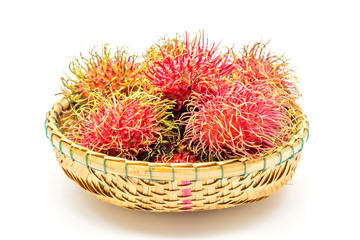 Fototapeta na wymiar fresh tropical rambutan fruits over basket on a white background, fruit in Thailand