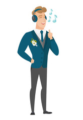 Groom listening to music in headphones.