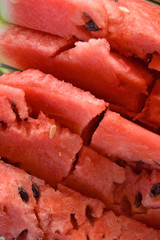 Cracked Sliced pieces of watermelon texture red background.