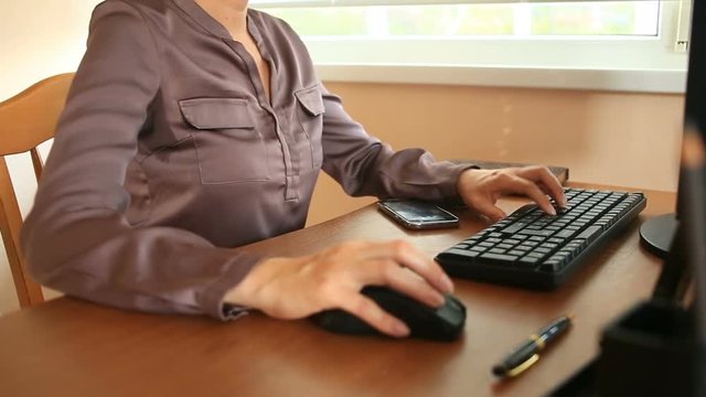 Woman with sweaty armpits. Girl sitting at the working place in office and sweating