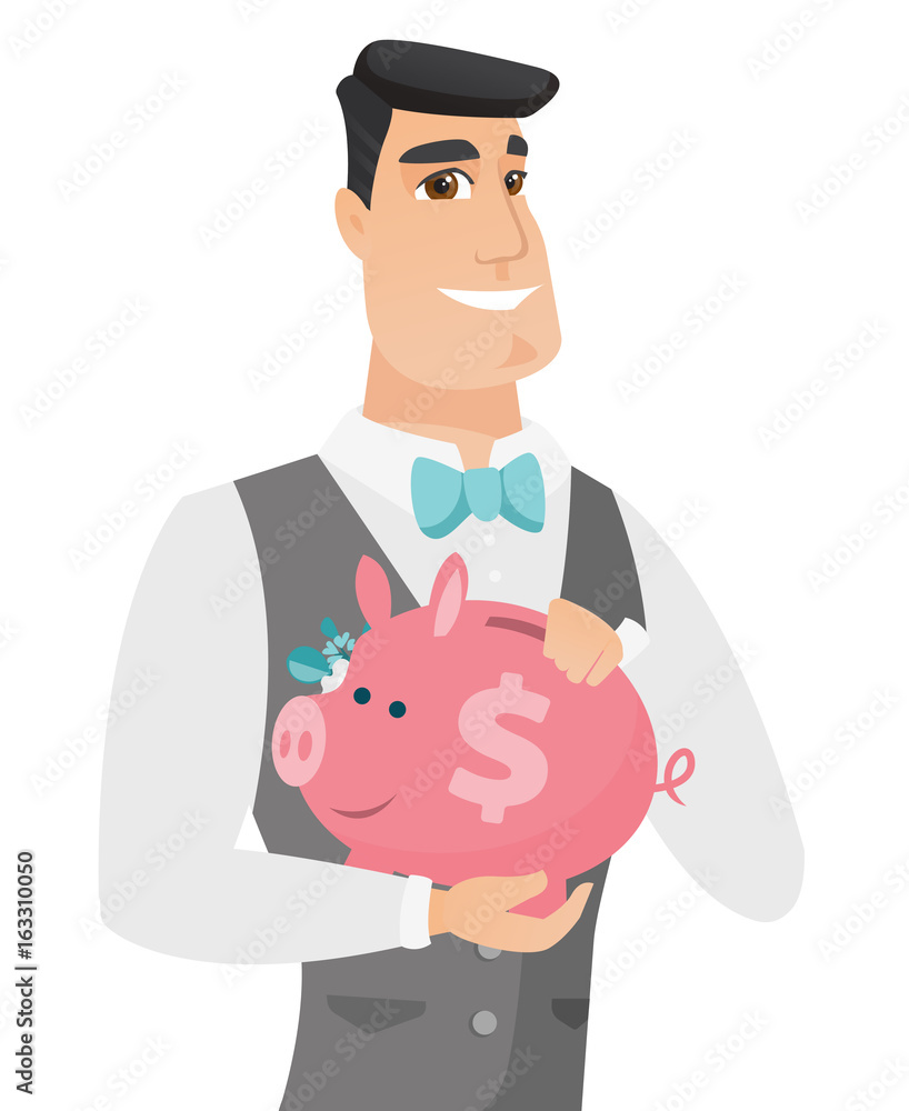 Canvas Prints Caucasian groom holding a piggy bank.