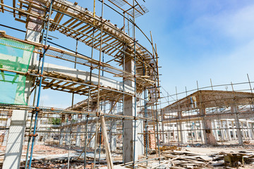 Demolition of  old buildings with roof only under blue sky