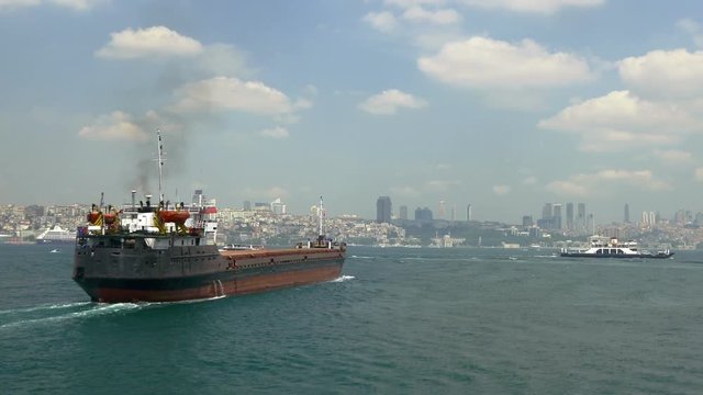 Tracking cargo freighter heading into straits of Istanbul from South. 48 sec. 30 fps UHD 4K Video. Bulk carriers are intended basically for carrying of bulk cargoes such as coal, timber, cement, vario