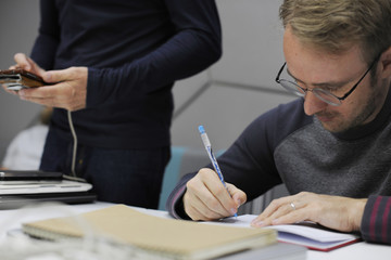 Startup Business People Writing on Notebook