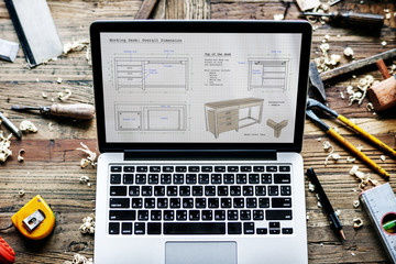 Closeup of computer notebook showing wooden furniture sketch plan