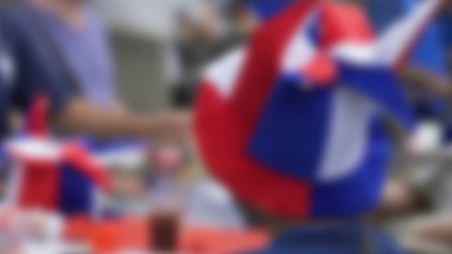Male football supporter with funny headgear waiting match and drinking beer