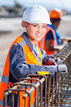 Worker Fixing Steel Rebar At Building Site