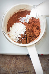 Brown sugar, milk, cocoa and corn flour - preparing chocolate pie filling 