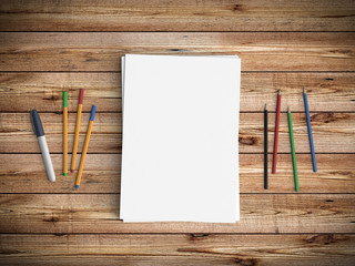 Obraz premium Minimal office desk workplace with blank paper, pencil and pen copy space on wood table background. Top view. Flat lay style.