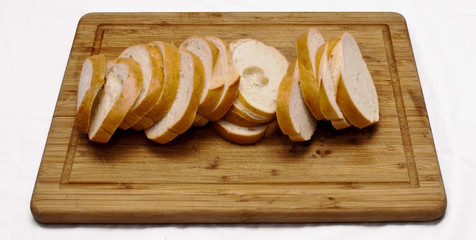 A loaf of bread sliced on a wooden cutting board